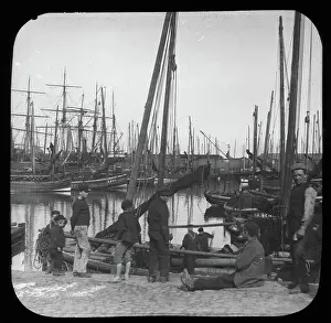 Moored Prints: Men and boys with sailing boats in port, unknown location, c1900s