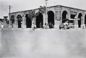 Two men in a car outside the Wellcome pharmaceutical depot in the Middle East, c1910.. Creator: Unknown