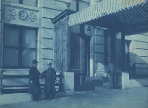 Two men, one a doorman, standing at the F. Street entrance to the Willard... between 1901 and 1910. Creator: Frances Benjamin Johnston