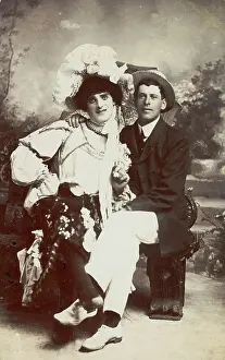 Lgbtqia Prints: Two men, one in drag, sit together on a bench, (between 1900 and 1901?). Creator: Unknown