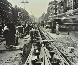 Roadworks Prints: Men laying tramlines in the middle of the road, Whitechapel High Street, London, 1929