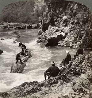 Men on a log raft, shooting the Hozu Rapids on the Katsura River, Kyoto, Japan, 1904. Artist: Underwood & Underwood