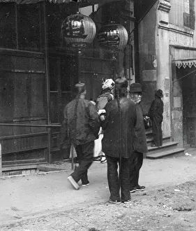 Lanterns Prints: Men standing or walking down a sidewalk