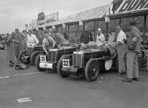 Car Maintenance Gallery: Three MG C type Midgets in the pits at the RAC TT Race, Ards Circuit, Belfast, 1932