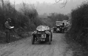Junior Car Club Prints: MG M Type and Riley saloon competing in the JCC Half-Day Trial, 1930. Artist: Bill Brunell