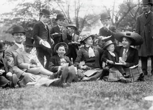 Picnic Prints: Midgets May Party - Central Park. Group seated on grass, 1910. Creator: Bain News Service