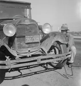 Okie Prints: Migrant worker from Oklahoma repairing tire on California highway