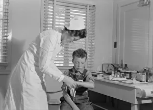 Bandaged Collection: Migratory boys come to the clinic for attention, FSA camp at Farmersville, Tulare County, 1939