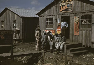 Sign Collection: Migratory laborers outside of a 'juke joint'during a slack season, Belle Glade, Fla. 1941