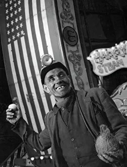 Miners Helmet Prints: Miner at a fairground, Conisbrough, near Doncaster, South Yorkshire, 1955. Artist