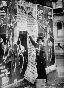 Posters Prints: Miss Louise Hall with brush and Susan Fitzgerald assisting bill posting