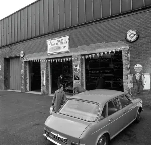 Motor Maintenance Gallery: Mk 1 BMC Austin 1800 outside a tyre fitting bay in Rotherham, South Yorkshire, 1969