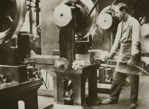 Metal Industry Prints: Money making; cutting strips of silver into disks, 20th century