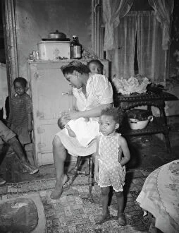 Parks Gordon Roger Alexander Buchanan Collection: A mother getting the children ready for a neighborhood birthday party, Washington, D.C. 1942