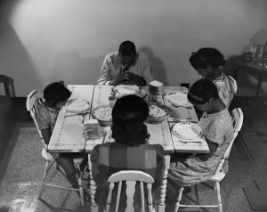 In Prayer Collection: Mr. Branch, resident of the James Creek dwellings, saying grace, Washington, D.C. 1942