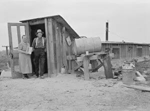 Mr. and Mrs. Wardlow at entrance to their dugout basement home, Dead Ox Flat, Oregon, 1939 Creator: Dorothea Lange