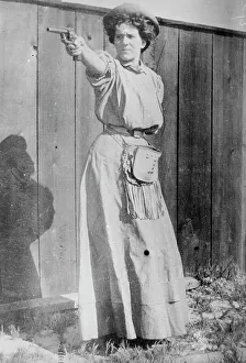 Cowgirl Prints: Mrs. Adolph Topperwein. [with gun], between c1910 and c1915. Creator: Bain News Service