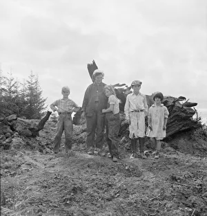 Pile Prints: Mrs. Arnold and her children before the stump pile