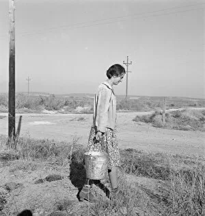 Displaced Person Gallery: Mrs. Bartheloma hauls water from irrigation ditch, Nyssa Heights, Malheur County, Oregon, 1939
