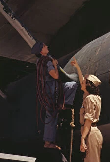 Aeronautics Gallery: Mrs. Cora Ann Bowen (left) works as a cowler at the Naval Air Base... Corpus Christi, Texas, 1942