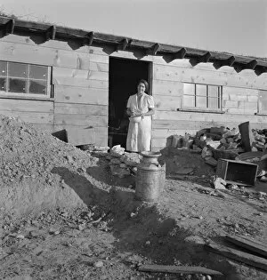 Mrs. Dougherty in doorway of basement house, Warm Springs, Malheur County, Oregon, 1939. Creator: Dorothea Lange