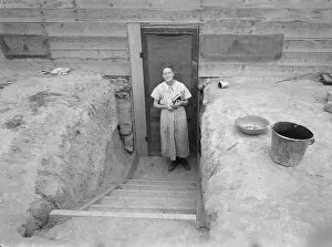Dugout Gallery: Mrs. Free in doorway of her basement dugout home, Dead Ox Flat, Oregon, 1939