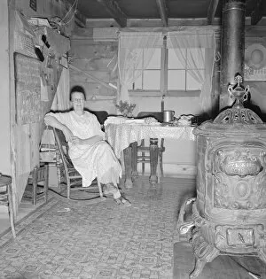 Shelter Collection: Mrs. Hull and corner of her one-room basement dugout, Dead Ox Flat, Malheur County, Oregon, 1939