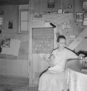 Underground Gallery: Mrs. Hull in one-room dugout basement home, Dead Ox Flat, Malheur County, Oregon, 1939
