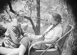 Mrs. Mary Benson and unidentified man, seated outdoors, 1933. Creator: Arnold Genthe