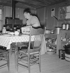 Dugout Gallery: Mrs. Wardlow bakes her own bread in her dugout house, Dead Ox Flat, Malheur County, Oregon, 1939