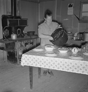 Dug Out Gallery: Mrs. Wardlow getting dinner after church in her basement... Dead Ox Flat, Oregon, 1939