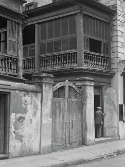 Multi-story house behind gated wall, New Orleans or Charleston, South Carolina, c1920-1926. Creator: Arnold Genthe