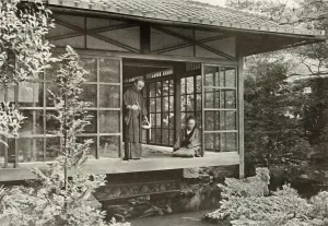 Traditional Culture Prints: Namikawa San Feeding His Carp, 1910. Creator: Herbert Ponting