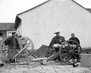 1871 Prints: Nanking, Kiangsu province, China: three men examining a gun at the arsenal