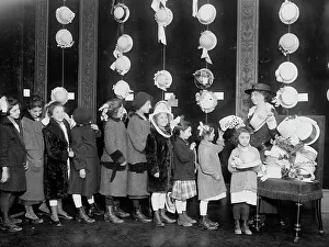 Distributing Prints: Natalie Stewart Distributing hats to poor children
