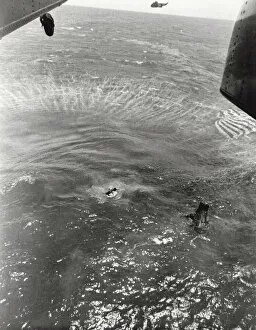 Navy frogmen swim to spacecraft to begin retrieval, Pacific Ocean, 1963. Creator: NASA