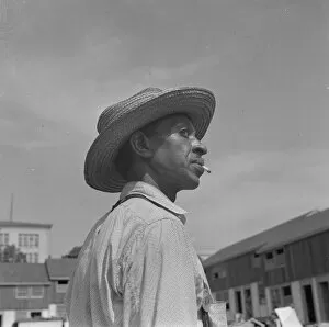 Straw Hat Collection: Negro waterboy for a housing construction gang, Washington, D.C. 1942. Creator: Gordon Parks