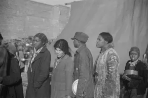 Bad Weather Gallery: Negroes at mealtime in the flood refugee camp, Forrest City, Arkansas, 1937. Creator: Walker Evans