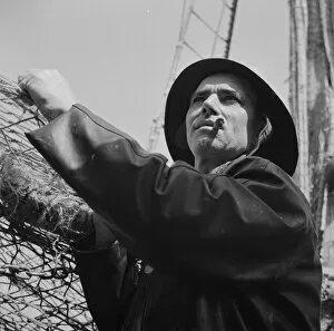 A New England fisherman preparing his boat to leave the New York docks, , New York, 1943. Creator: Gordon Parks