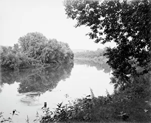 Riverfront Prints: New Ulm, Minn. river view, reflections, between 1880 and 1899. Creator: Unknown