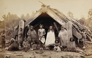 Aotearoan Prints: New Zealand: a group of Maori in front of a traditional building
