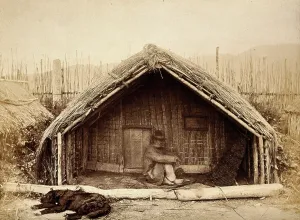Aotearoan Prints: New Zealand: a Maori man sitting in front of a traditional house