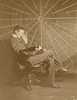 Tesla Prints: Nikola Tesla and his spiral oscillating transformer, 1896. Creator: Anonymous