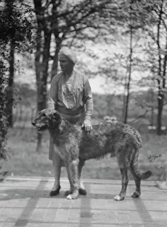 Portrait Photographs Prints: Noland, Charlotte, Miss, with dog, standing outdoors, 1931 May 8. Creator: Arnold Genthe