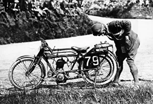 Norton Prints: Norman Black repairing a punture on his Norton bike, 1920