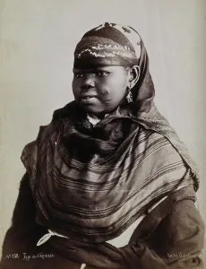 Stripe Prints: A North African woman with scarification on her cheeks, c1900. Creator: Gabriel Lekegian