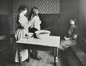 Finsbury Prints: A nurse examines girls hair, Central Street Cleansing Station, London, 1914