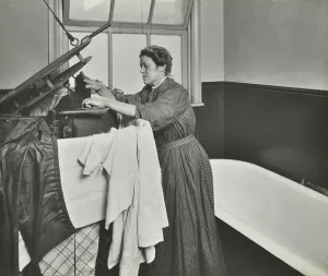 Stepney Prints: Nurse using a steriliser in the bathroom at Chaucer Cleansing Station, London, 1911