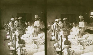 Casualty Collection: Nurses and a doctor attending wounded soldiers on a hospital ward, c1905