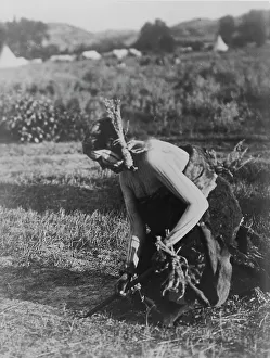 Face Paint Prints: Offering the pipe to the Earth-Cheyenne, c1910. Creator: Edward Sheriff Curtis